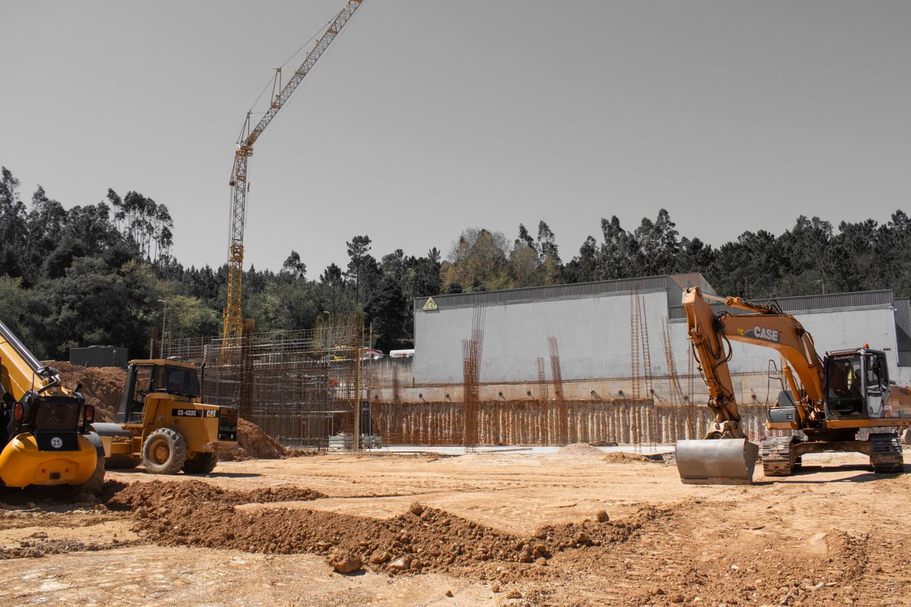 A busy construction site with cranes and heavy machinery for building infrastructure.